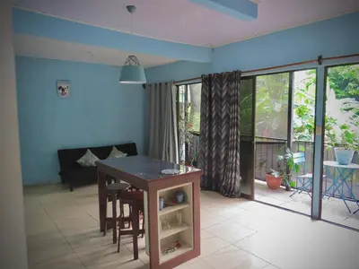 a living room with a table and a couch at Rose House Manuel Antonio in Quepos