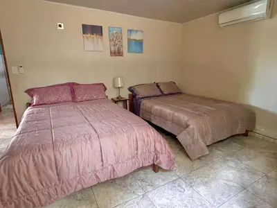 a bedroom with two beds in a room at Cabinas La Catarata in Fortuna