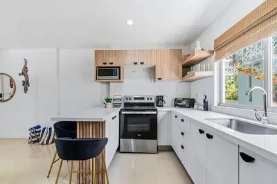 a white kitchen with a sink and a stove at VVII2 2 bdrm with ensuite bathrms in centre of town in Tamarindo