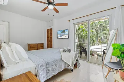 a bedroom with a bed and a ceiling fan at VVII2 2 bdrm with ensuite bathrms in centre of town in Tamarindo