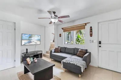 a living room with a couch and a ceiling fan at VVII2 2 bdrm with ensuite bathrms in centre of town in Tamarindo