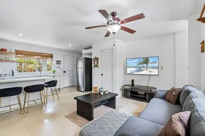 a living room with a couch and a ceiling fan at VVII2 2 bdrm with ensuite bathrms in centre of town in Tamarindo