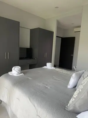 a bedroom with a large bed with two pillows on it at Casa blue in Jacó