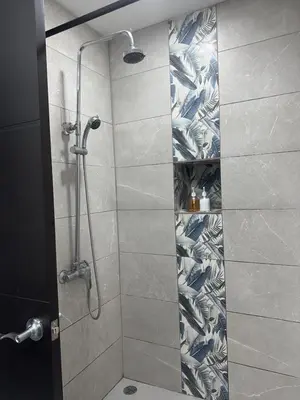 a bathroom with a shower with a glass door at Casa blue in Jacó