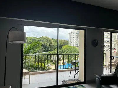 a room with a balcony with a view of a building at Casa blue in Jacó