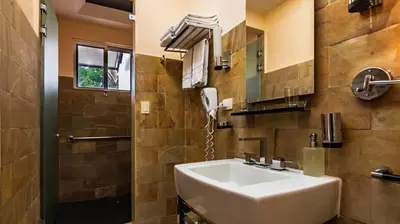 a bathroom with a sink and a shower at Gaia Collection Hotels Manuel Antonio in Manuel Antonio