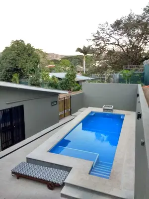 a swimming pool on the roof of a house at Happy Face House in Bogee