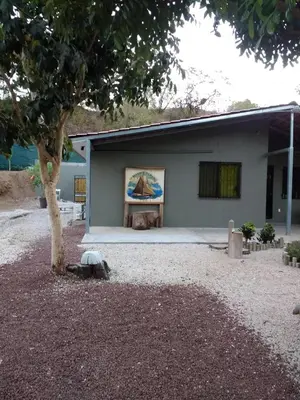 a building with a painting on the side of it at Happy Face House in Bogee
