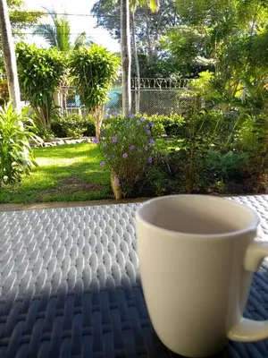a cup of coffee sitting on a table at Happy Face House in Bogee