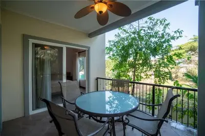a patio with a table and chairs on a balcony at 3-BD Beauty with Pool Near Beach in Santa Cruz