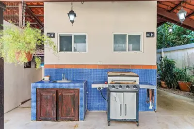 a outdoor kitchen with a stove and a sink at 3-BD Beauty with Pool Near Beach in Santa Cruz