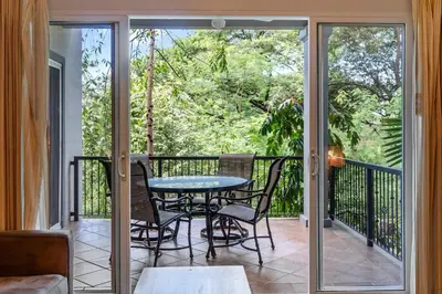 a patio with a table and chairs on a balcony at 3-BD Beauty with Pool Near Beach in Santa Cruz