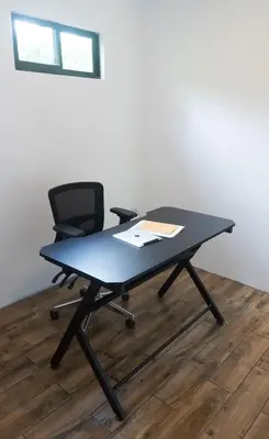 a black desk with a chair and a table at Holly House La Fortuna in Agua Azul