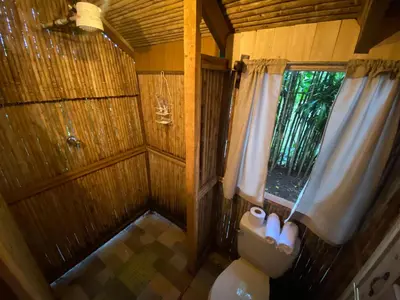 a small bathroom with a toilet and a window at Casa del Arbol Feel Good in Naranjo