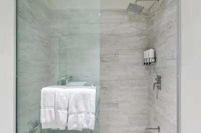a white bathroom with a sink and a shower at Nice&Cozy Loft URBN Escalante in San José