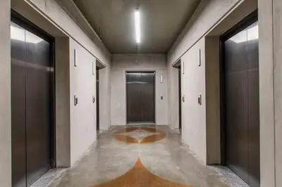 an empty hallway with doors and a rug on the floor at Nice&Cozy Loft URBN Escalante in San José