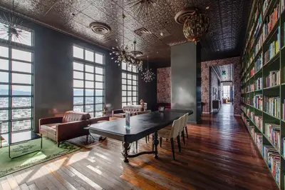 a room with a library with a table and chairs at Nice&Cozy Loft URBN Escalante in San José