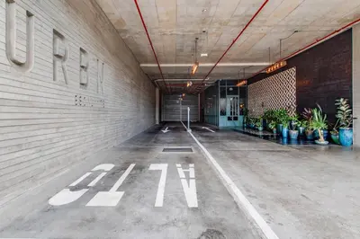 an empty parking lot in a building with plants at Nice&Cozy Loft URBN Escalante in San José