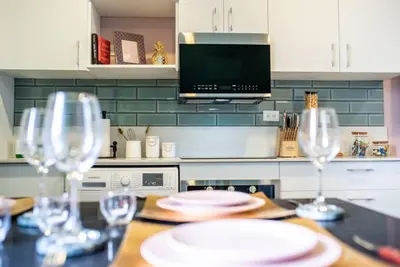 a kitchen with a table with wine glasses on it at Nice&Cozy Loft URBN Escalante in San José