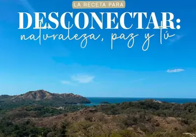 a view of the ocean and mountains with the words descendacion neichenigera at Finca Brisas de la Montaña in Coco