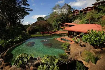 a resort with a swimming pool and a building at Peace Lodge in Vara Blanca