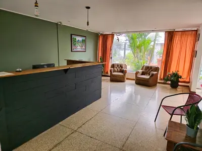 a lobby with a bar and chairs and a window at Haven Hotel in San José