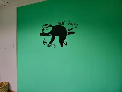 a wall decal of a monkey on a green wall at Haven Hotel in San José