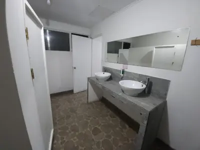 a bathroom with two sinks on a concrete counter at Haven Hotel in San José