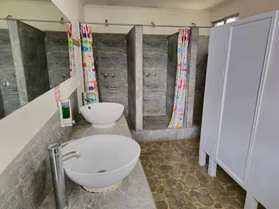 a bathroom with a toilet and a sink and a shower at Haven Hotel in San José