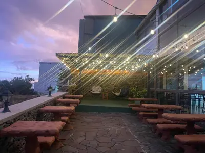 a patio with benches and lights on the side of a building at Cabinas Vista Al Golfo in Monteverde Costa Rica