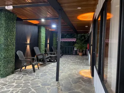 a patio with chairs and tables and a ceiling at Cabinas Vista Al Golfo in Monteverde Costa Rica