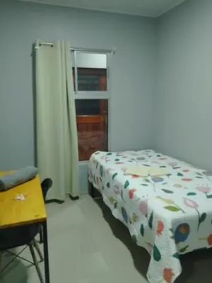 a bedroom with a bed and a window at Hospedaje Casa Académica in San Pedro