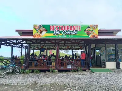 a group of people standing on a restaurant bus ride at Cabinas Río celeste in Upala