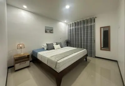 a bedroom with a large bed and a window at Condo Apt 3BR,2BA, 4mi from SJO Airport, Pool,Gated, Gym in Desamparados