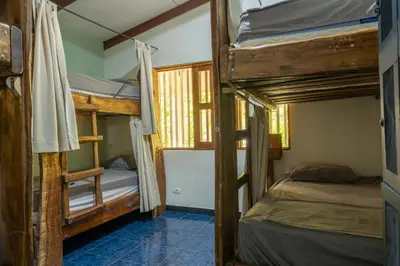 a bedroom with two bunk beds in a room at Tropical Camas Surf House in Pochotal
