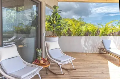 a patio with two chairs and a bowl of fruit at Blanko Mar Ocean view in Santa Teresa Beach