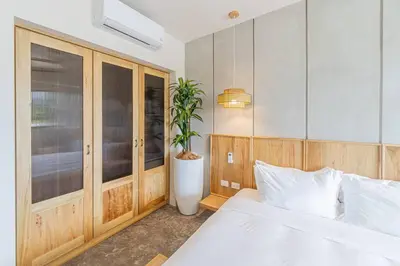 a bedroom with a white bed and a potted plant at Blanko Mar Ocean view in Santa Teresa Beach