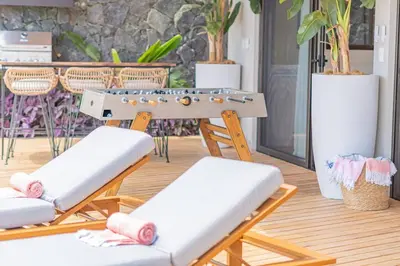 two lounge chairs and a ping pong table at Blanko Mar Ocean view in Santa Teresa Beach