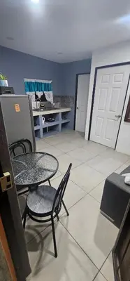 a room with a table and chairs and a garage at Villas Atardecer Tamarindo in Santa Rosa
