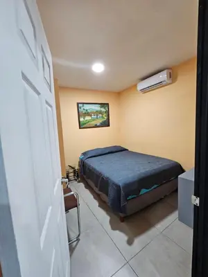 a bedroom with a bed and a air conditioner at Villas Atardecer Tamarindo in Santa Rosa