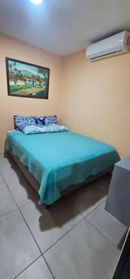 a bedroom with a bed and a air conditioner at Villas Atardecer Tamarindo in Santa Rosa