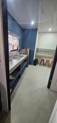 a kitchen with a sink and a table at Villas Atardecer Tamarindo in Santa Rosa