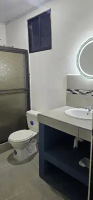 a bathroom with a toilet and a sink at Villas Atardecer Tamarindo in Santa Rosa