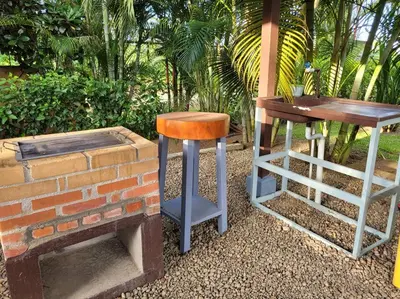two bar stools sitting next to a brick wall at Arenal Family Home - Families & Friends Gateway in Fortuna