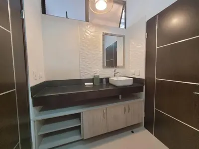 a bathroom with a sink and a mirror at Villa Arthur La Fortuna in Fortuna