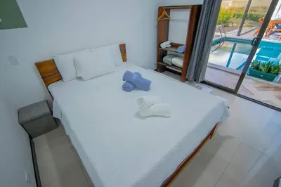 a bedroom with a bed with a blue object on it at Villa Arthur La Fortuna in Fortuna