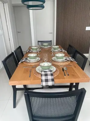 a wooden table with plates and dishes on it at Exclusivo Apartamento en Sabana in Uruca