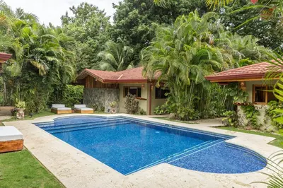 a swimming pool in front of a house at Villas Santa Teresa in Santa Teresa Beach