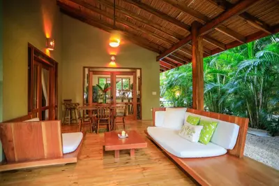 a living room with a couch and a table at Villas Santa Teresa in Santa Teresa Beach