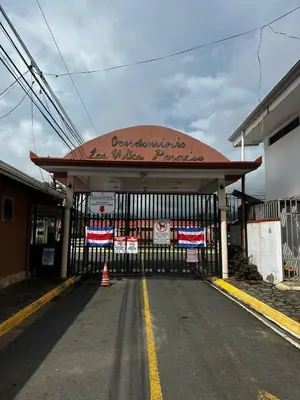 a gas station with a sign on top of it at In the HEART of Jaco at Villas Paraiso in Jacó